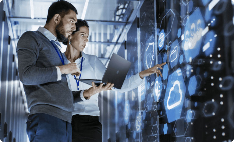 Two employees reviewing digital cloud.