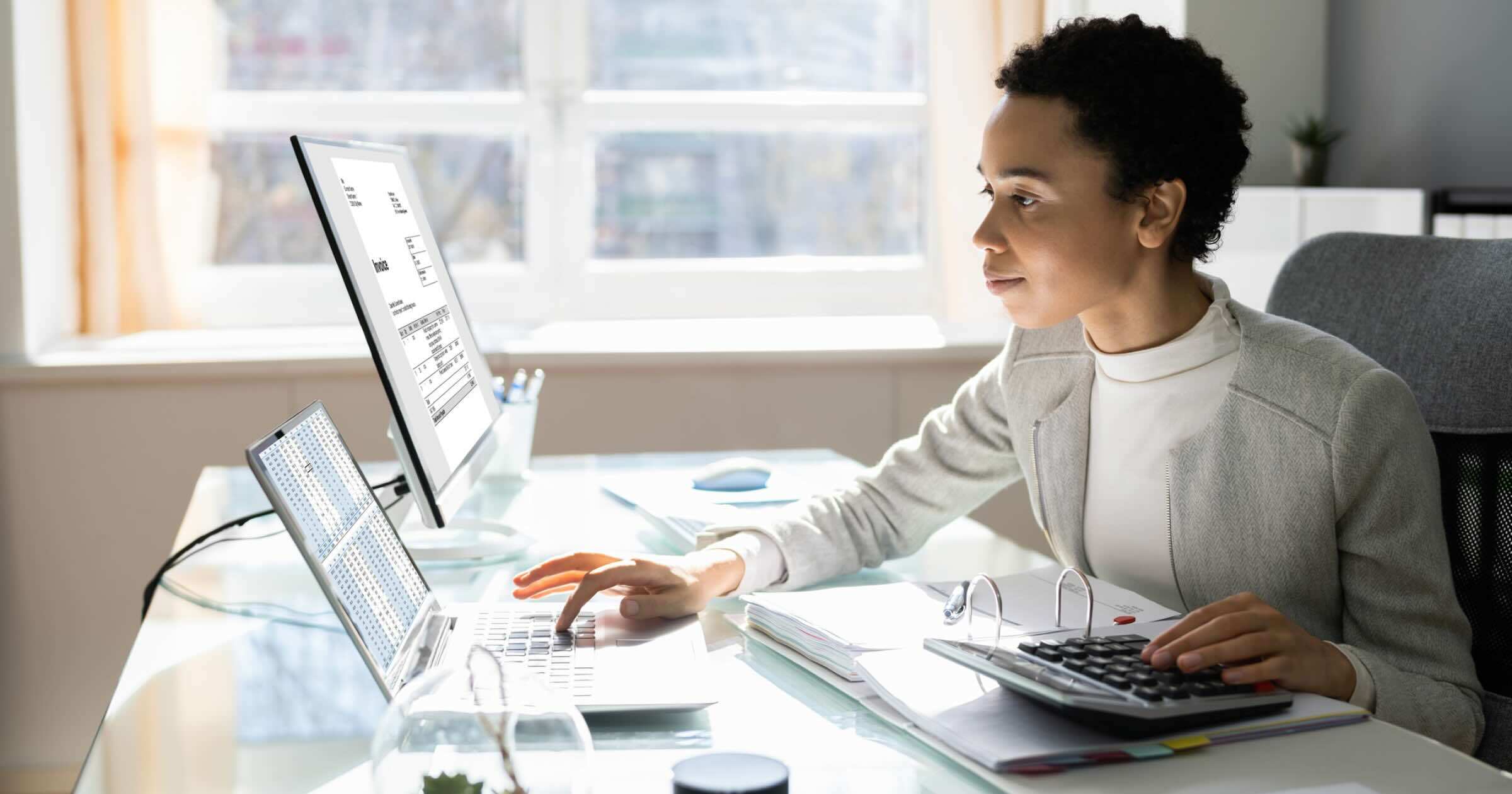 Professional reviewing print audit data and analytics dashboard to identify print costs, usage trends, and optimization opportunities across enterprise print operations