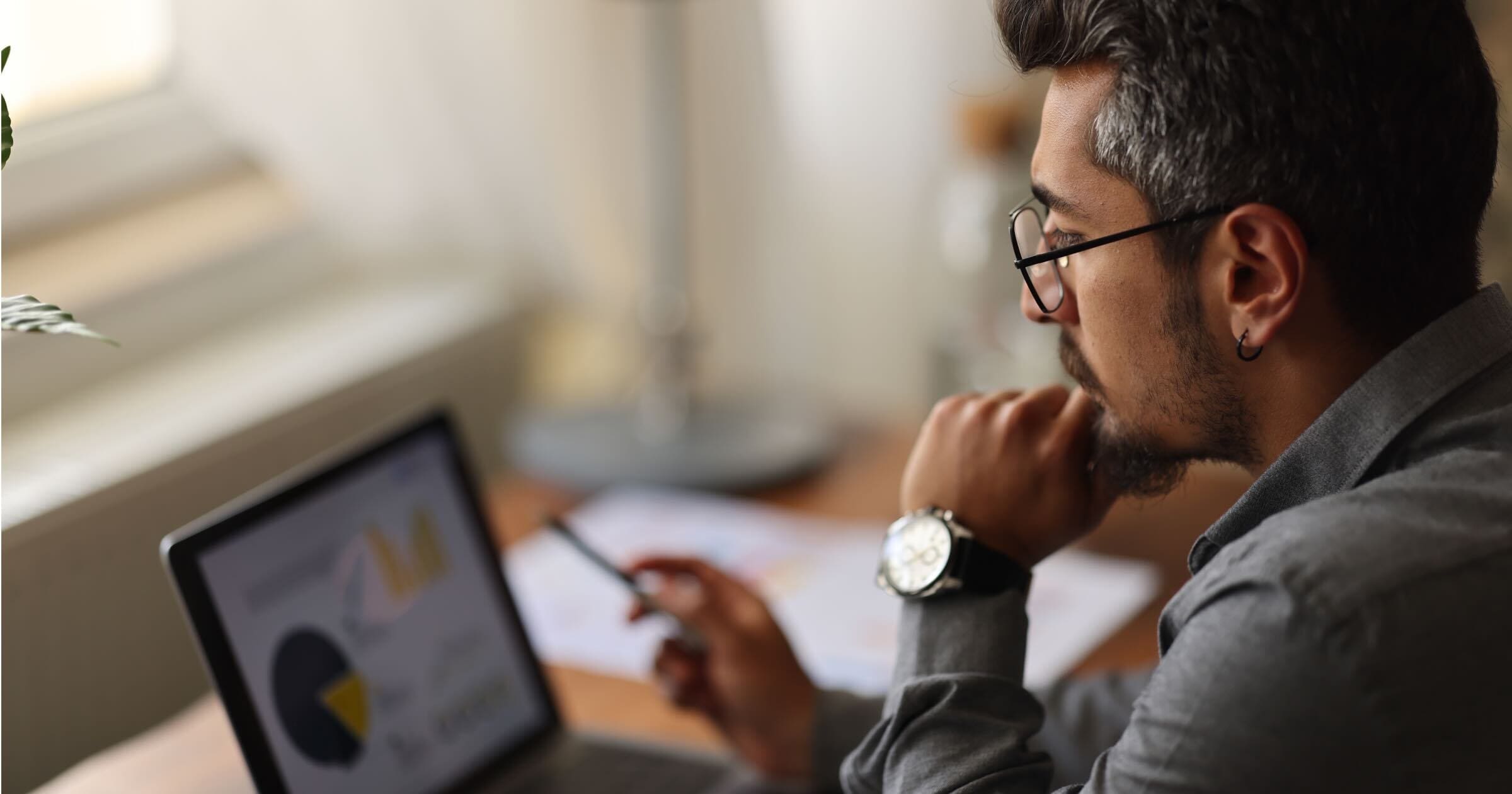 IT professional reviewing print security analytics and compliance reporting on a digital dashboard