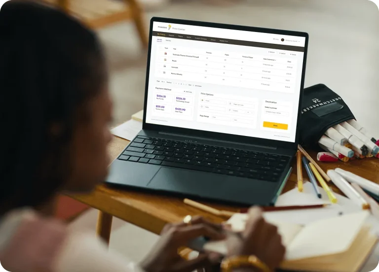 User accessing cloud print management software on a laptop to submit, track, and manage print jobs remotely