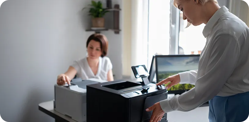 Office employee using secure release printing to authenticate and retrieve documents from a network printer