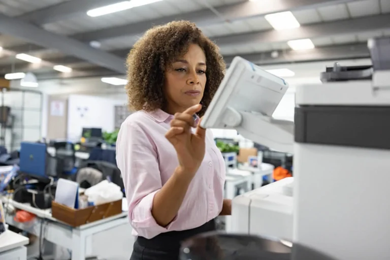 employee operating a printer in the office
