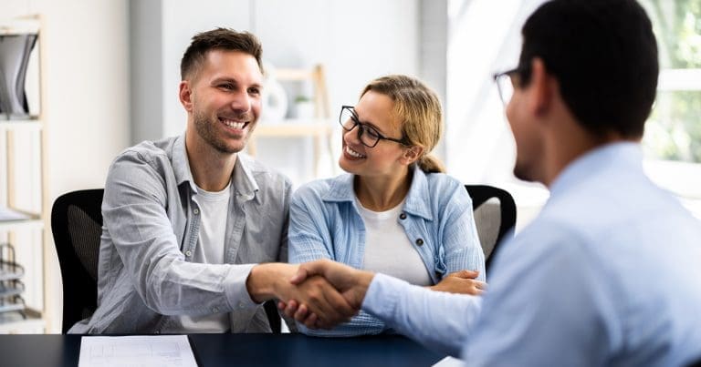 insurer shaking hands with an employee