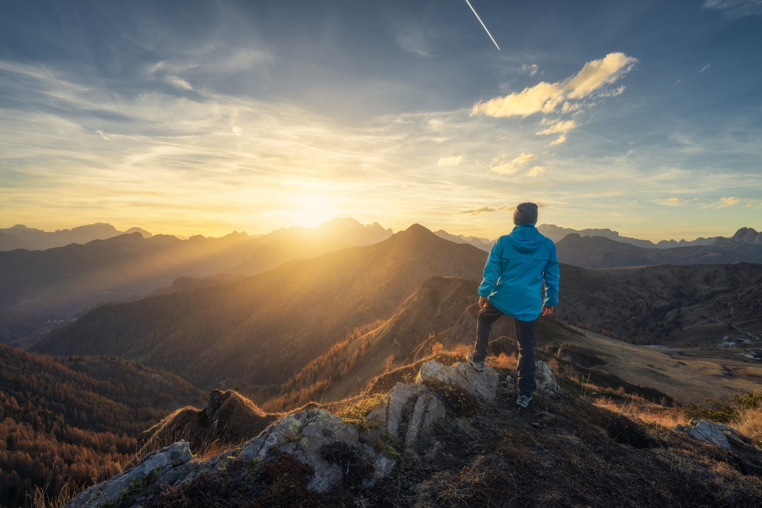 man looking at horizon on a mountain