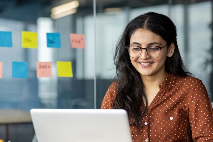 IT professional working on a laptop, representing identity-driven, cloud-managed print architecture designed to reduce friction and improve security.